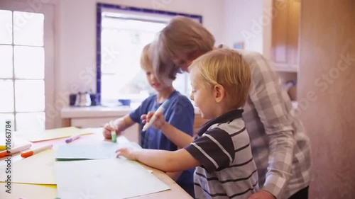 Wallpaper Mural Elderly babysitter drawing with two cute white children Torontodigital.ca