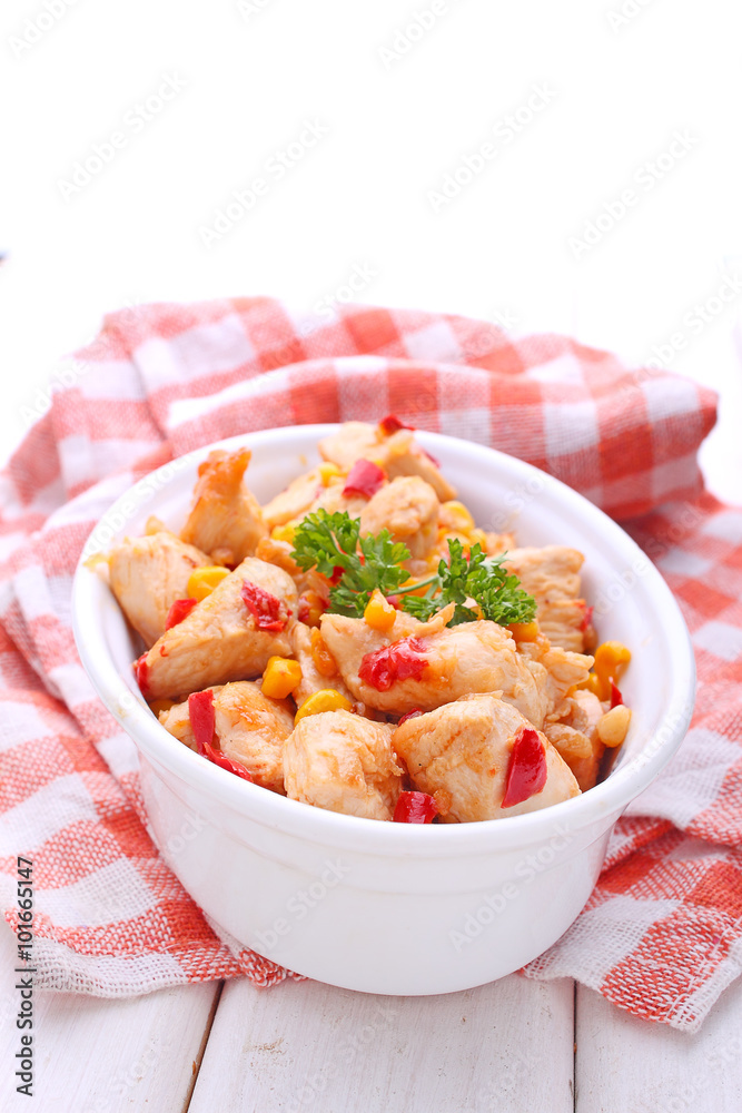 chicken with corn and bell pepper in a dish on a white background chicken with corn and bell pepper in a dish on a white background