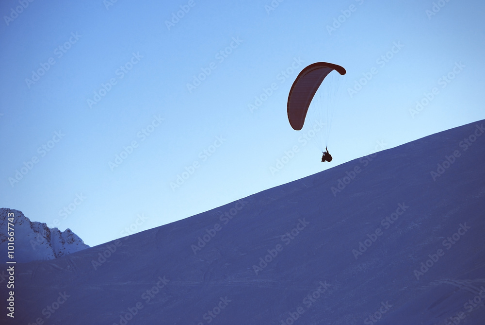 paragliding in winter in mouintans, sunset with paragling paragliding in winter in mouintans, sunset with paragling