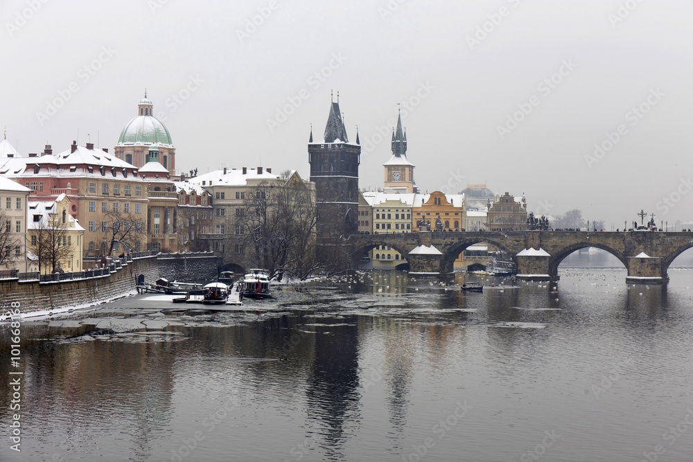 View on romantic snowy and foggy Prague Old Town with Charles Bridge, Czech Republic