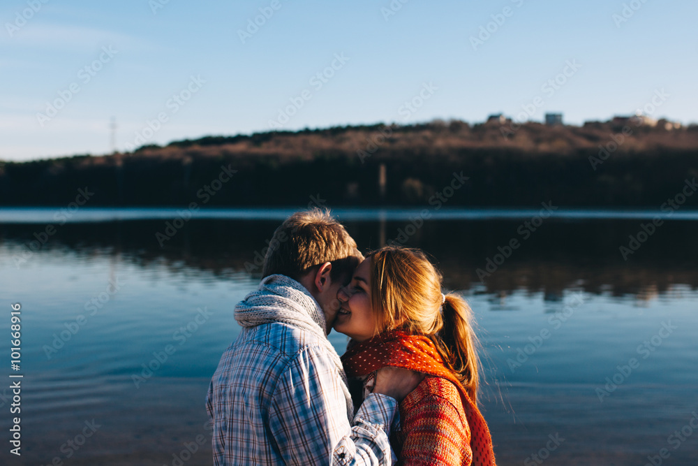 Teenage young couple in love at lake