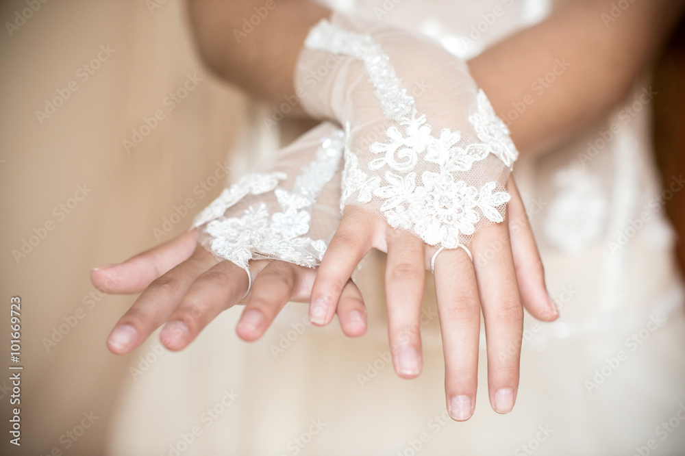 Wedding hands with white sleeves in the foreground