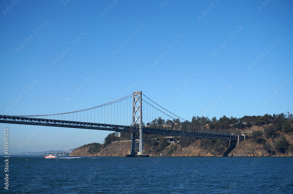 Bay Bridge, yerba buena island and boat sailing under Bay Bridge, yerba buena island and boat sailing under