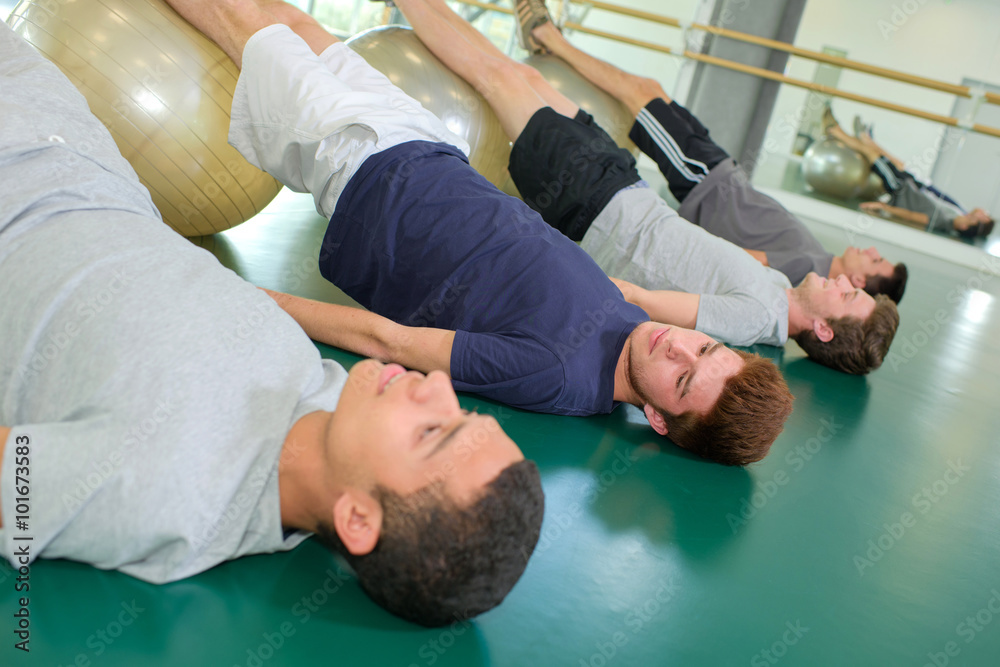 young men doing exercise young men doing exercise