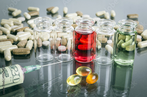 small bottles with pills along with a syringe, concept of sanita photo