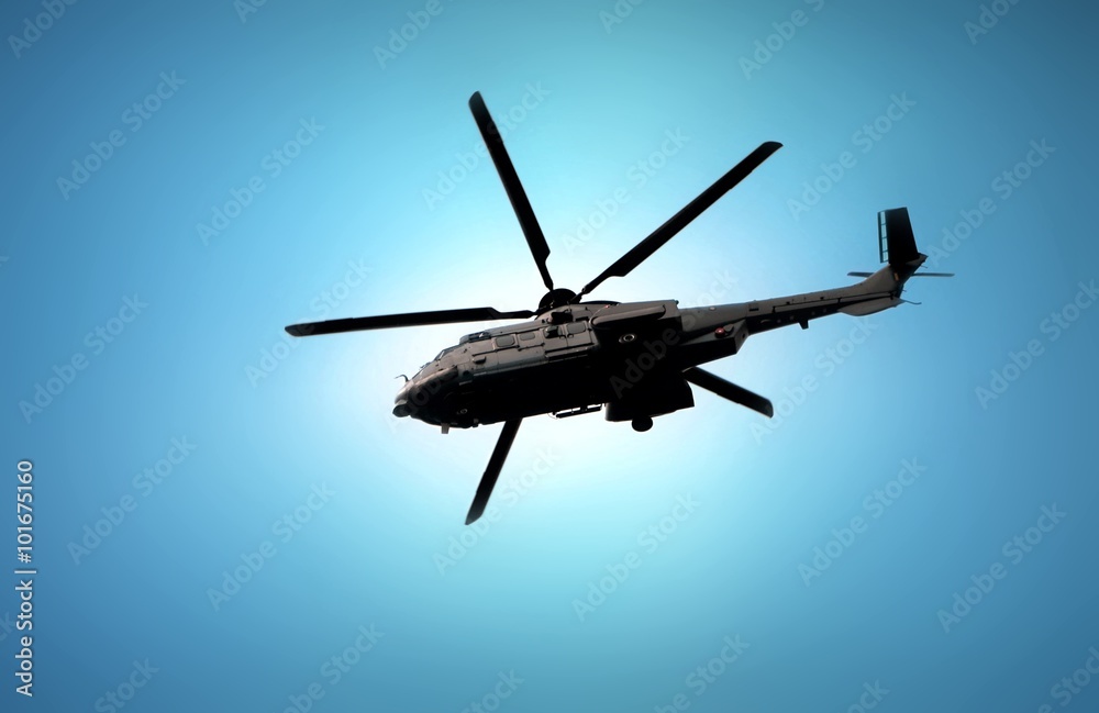 Military helicopter flying under blue sky Military helicopter flying under blue sky