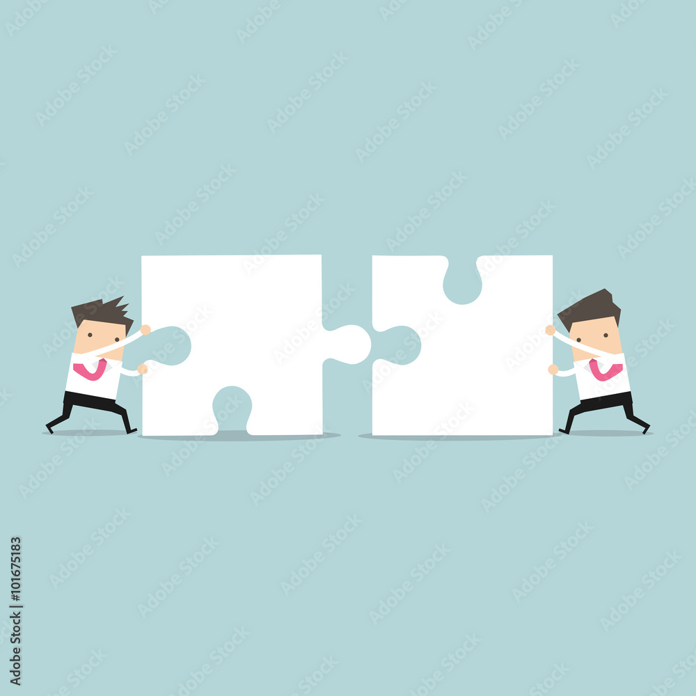 Fotografie Businessman teamwork pushing jigsaw together