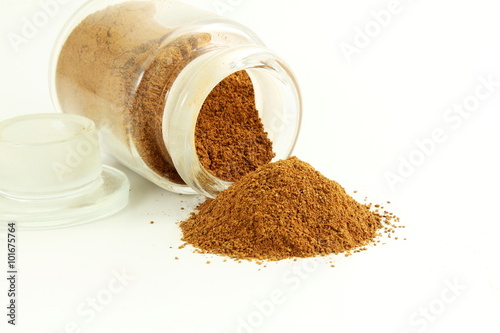 cinnamon  powder in bottle  closeup isolated on white background