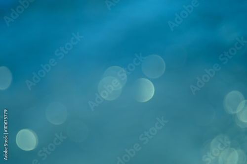 Blur tropical beach with bokeh wave sun light abstract background.