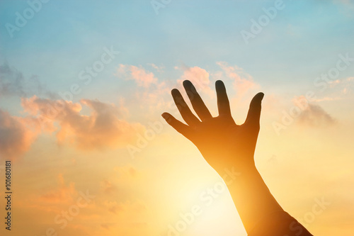 hand holding the sky in sunset