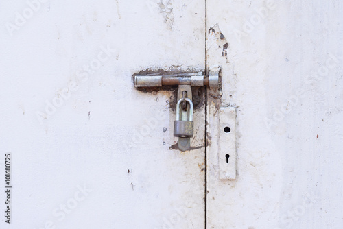 Locked door, grunge metal with rust doors. © Eakkaluk