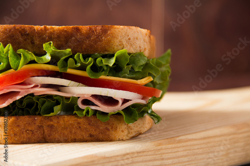 Sandwich with tomato on a wooden table