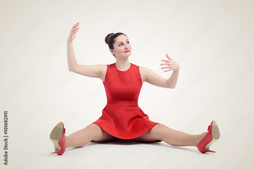 Girl style doll in red, sitting on the floor Girl style doll in red, sitting on the floor