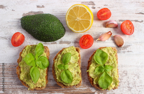 Freshly sandwiches with paste of avocado and ingredients, healthy food and nutrition