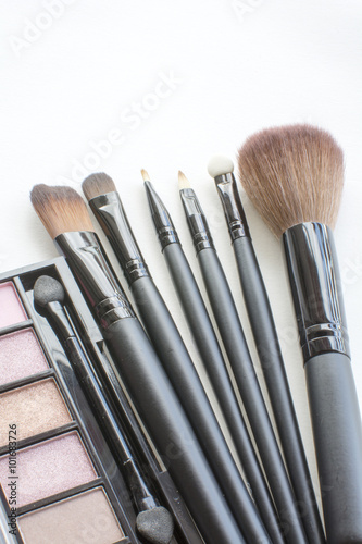 makeup brushes set and eye kit on white backgrounds