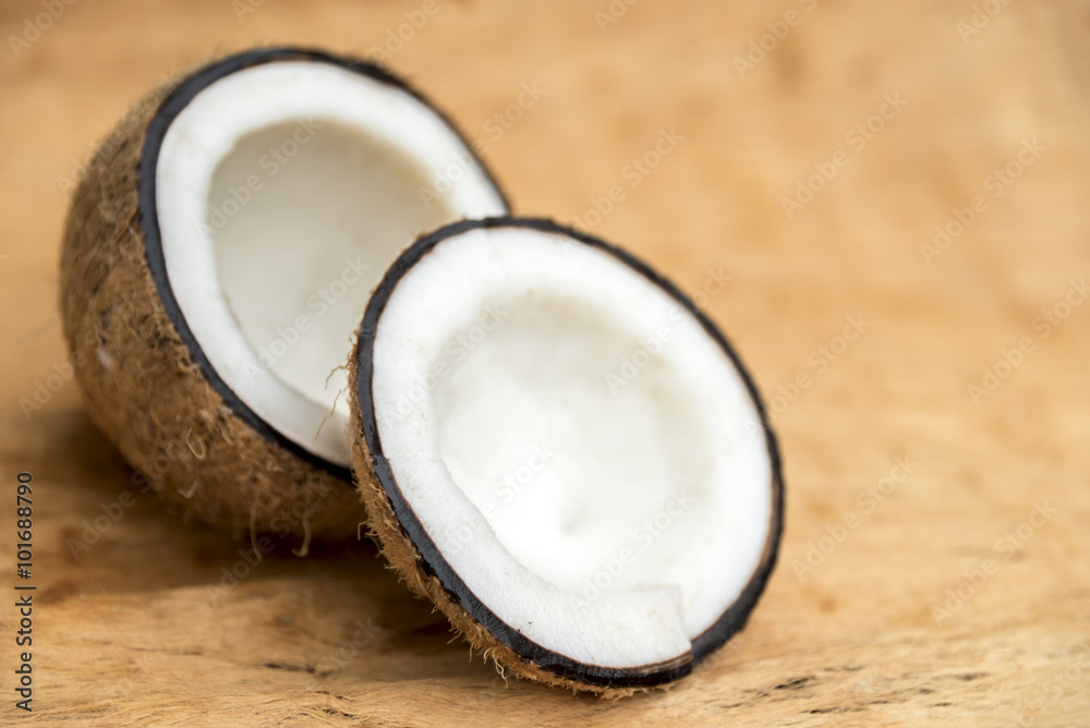 Old coconut cut in two parts with negative space Old coconut cut in two parts with negative space