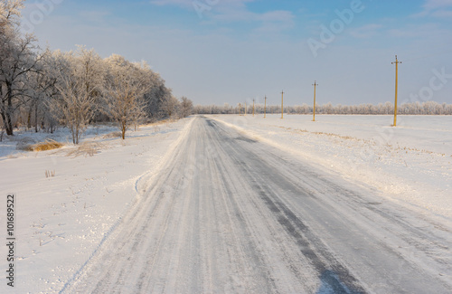 Winter landscape with country road covered by ice in central Ukraine © Yuri Kravchenko
