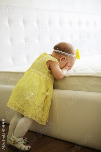 little girl with closed eyes in the room