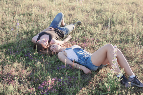 young couple relaxing on the lawn on meadow
