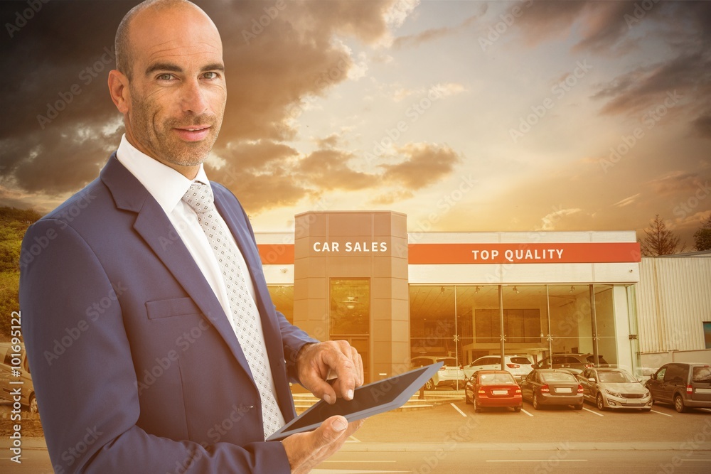 Fotografie Composite image of businessman using a tablet