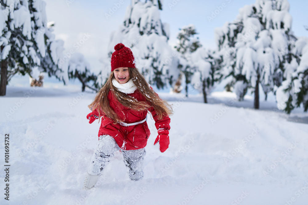 Girl runs and rejoices in  snowy park