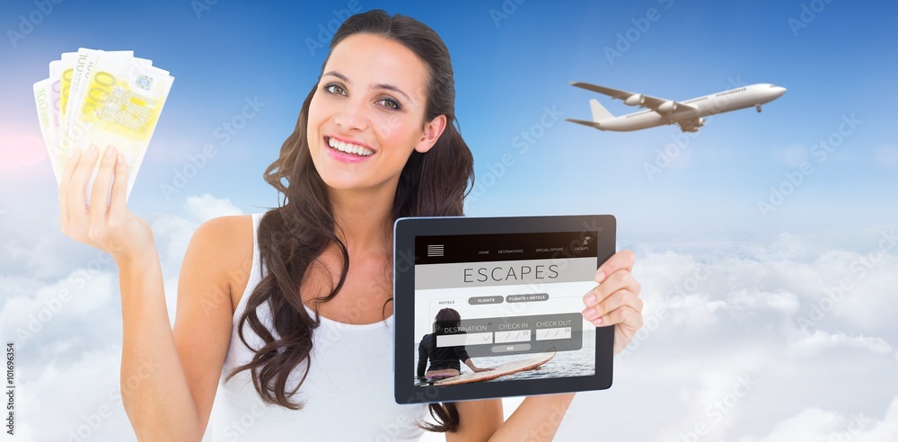 Composite image of pretty brunette using tablet pc Composite image of pretty brunette using tablet pc