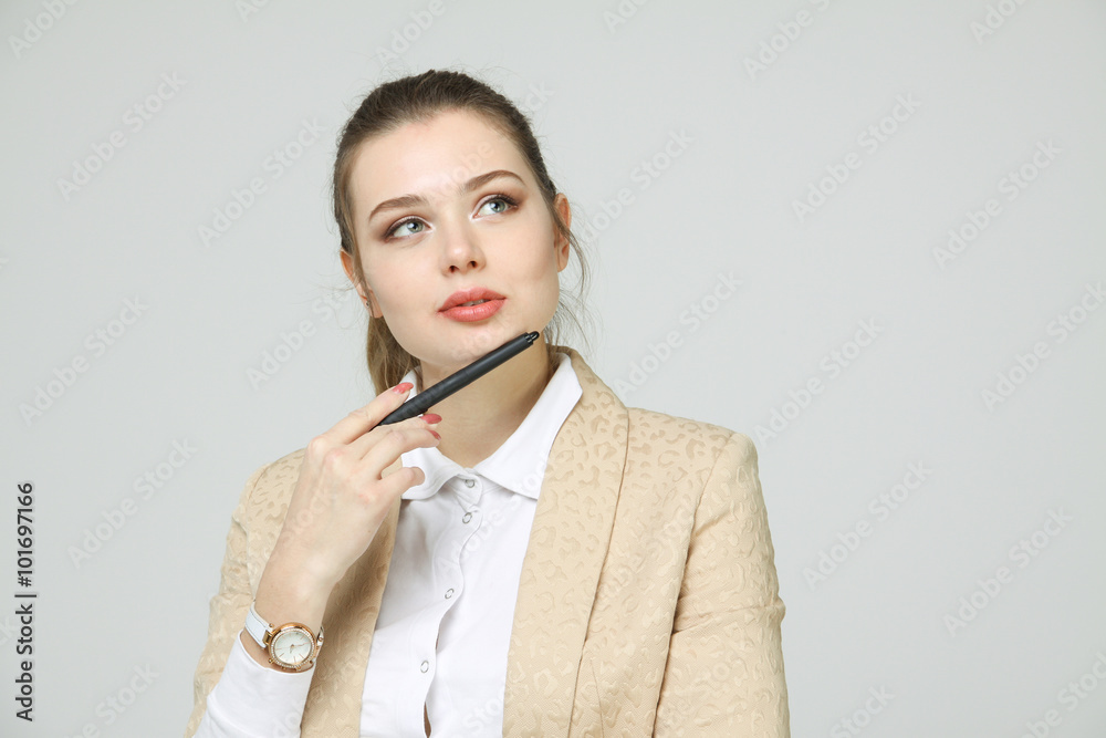 Young business woman thinking, holding pen in hand Young business woman thinking, holding pen in hand
