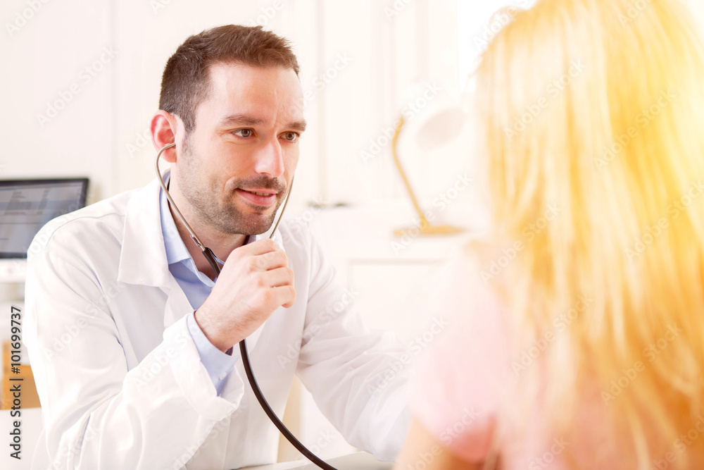 Fototapeta premium Young attractive doctor listening his patient