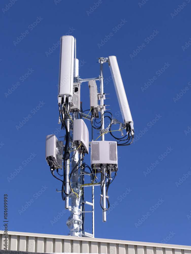Close up white color antenna repeater tower on blue sky