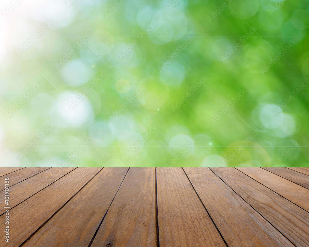 Wooden plank and bright spring bokeh background - can be used for display your products Wooden plank and bright spring bokeh background - can be used for display your products