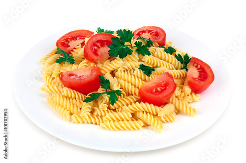 pasta fusilli with fresh tomatoes and herbs in a plate on white isolated background