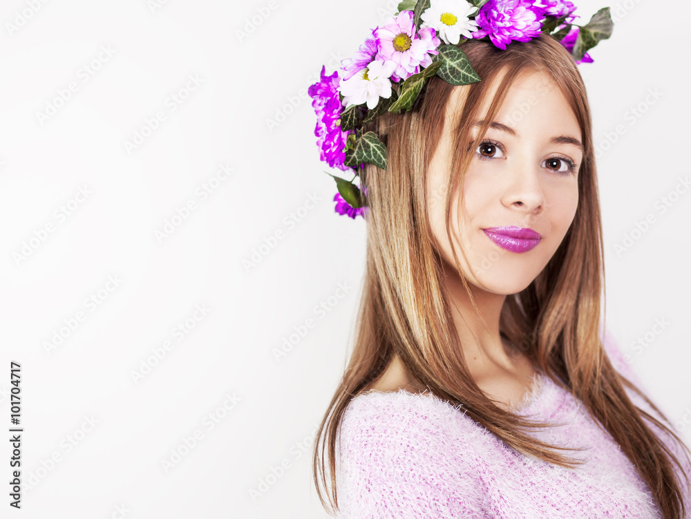 Young pretty brunette girl with flowers in a hair, isolated on white background. Head and shoulders. Studio shoot. Young pretty brunette girl with flowers in a hair, isolated on white background. Head and shoulders. Studio shoot.