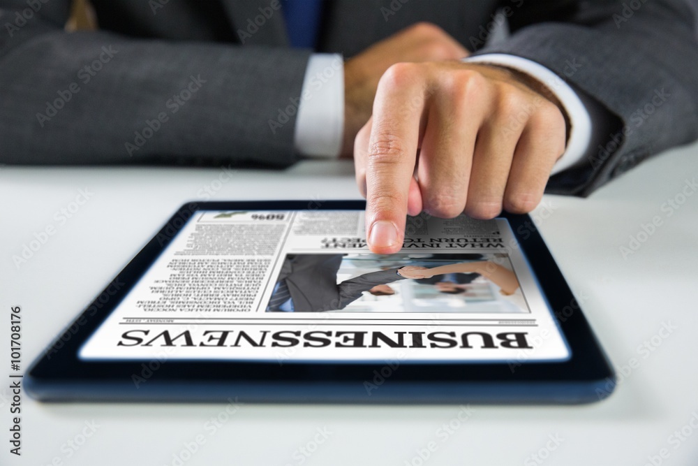Fotografie Composite image of businessman using digital tablet