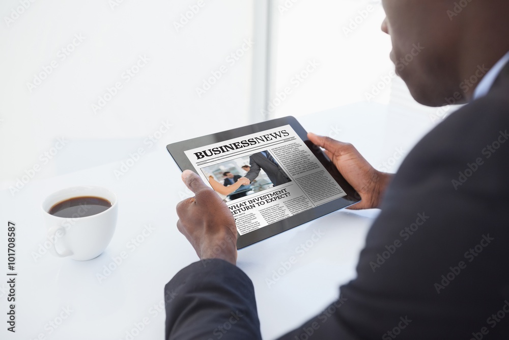 Fotografie Composite image of businessman using digital tablet