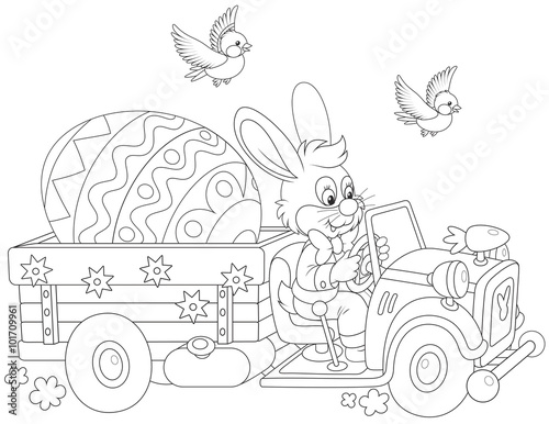 Easter Bunny driving a truck with a big decorated egg