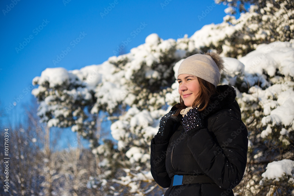 portrait of happy woman in snowy winter forest
