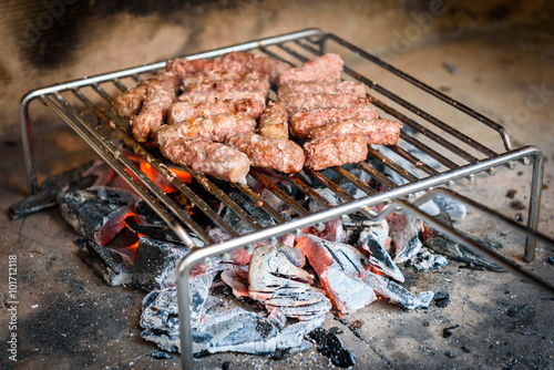 Grilling Meat on barbecue grill with coal.