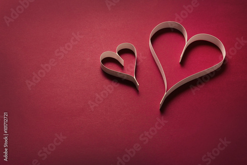 Paper hearts on a red background
