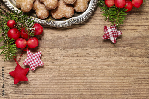 Paradise apples (Malus pumila Mill) and fir on wooden background