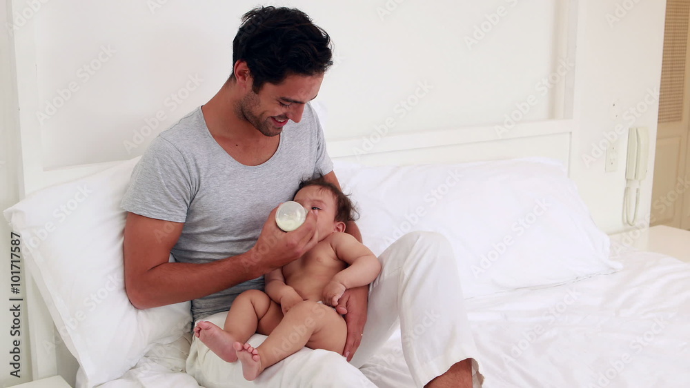 Handsome father feeding his baby Handsome father feeding his baby