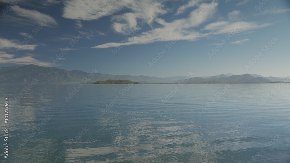 The lake view with small waves and islands, hills and cloudy sky on the background. 4k The lake view with small waves and islands, hills and cloudy sky on the background. 4k