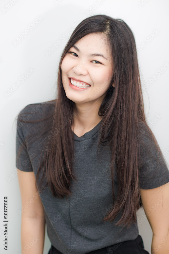 Bautiful asian girl smiling on gray background studio Bautiful asian girl smiling on gray background studio