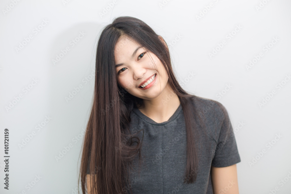 Bautiful asian girl smiling on gray background studio Bautiful asian girl smiling on gray background studio