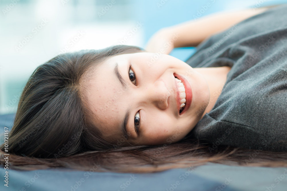 Fashion photo of beautiful young asian woman lying on the bed Fashion photo of beautiful young asian woman lying on the bed