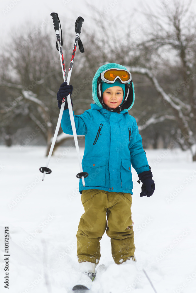 The boy in a blue jacket on skiing outdoor winter day