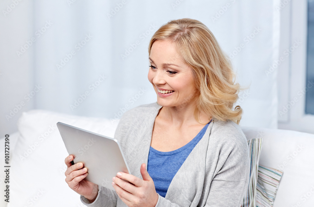happy middle aged woman with tablet pc at home happy middle aged woman with tablet pc at home
