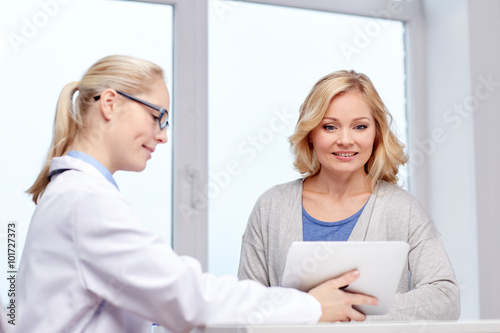 doctor with tablet pc and woman at hospital