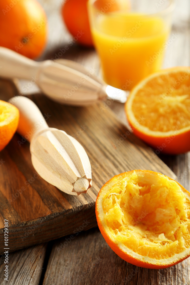 Wooden juicer and orange on a wooden table