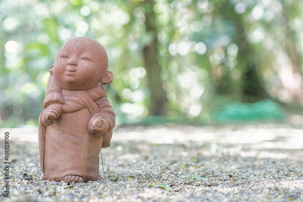 Αυτοκόλλητο Statue neophyte was walking on stone flooring with a background bokeh