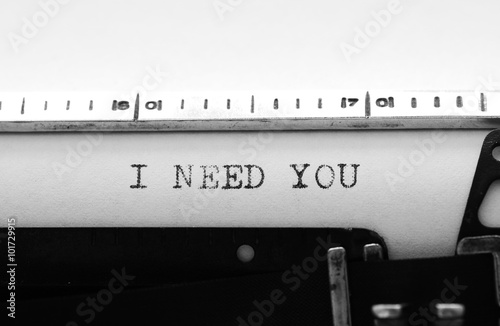 Typewriter. Typing text: I need you